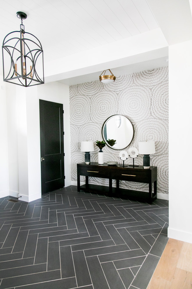 This is an example of a mid-sized country foyer in Salt Lake City with white walls, porcelain floors, a single front door, a black front door and black floor.