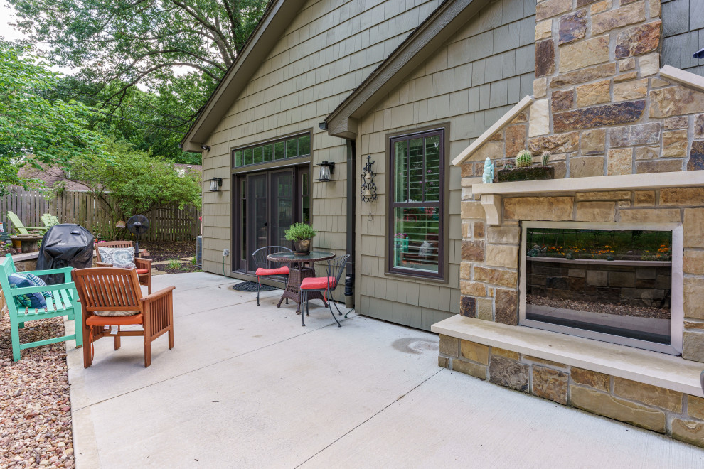 This is an example of a large backyard patio in Kansas City with with fireplace and concrete slab.
