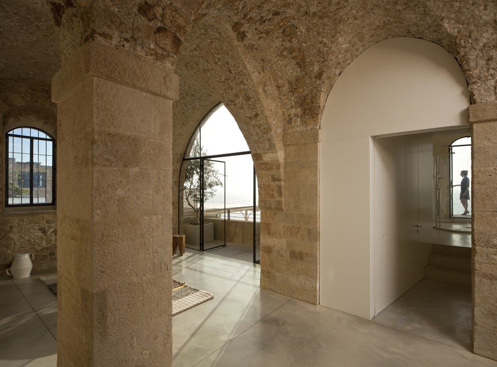 Mediterranean entryway with concrete floors.