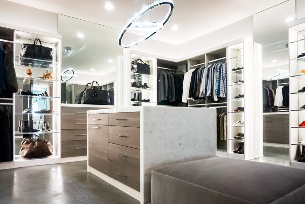 Inspiration for a large modern gender-neutral dark wood floor and brown floor walk-in closet remodel in Las Vegas with open cabinets and dark wood cabinets