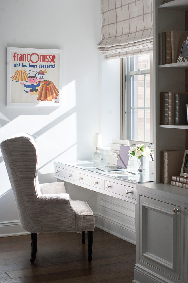 Photo of a transitional home office in Philadelphia with white walls, dark hardwood floors, a built-in desk and brown floor.
