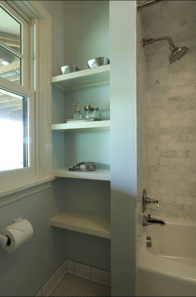 Small transitional bathroom in Portland with a wall-mount sink, a corner tub, a shower/bathtub combo, a one-piece toilet, gray tile, stone tile, grey walls and porcelain floors.