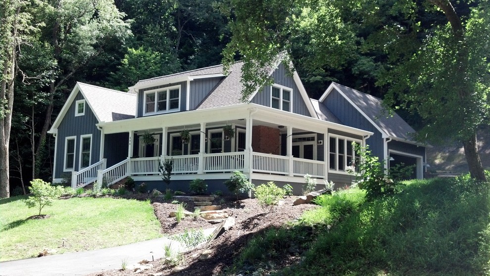 This is an example of a mid-sized country two-storey brown exterior in Charlotte with mixed siding.