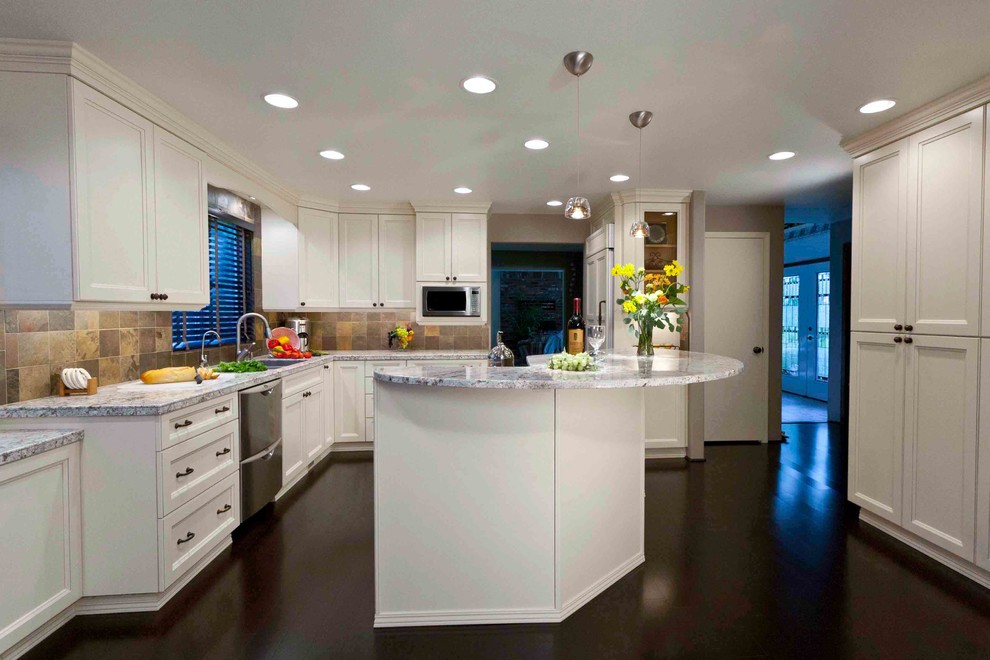 Large transitional galley dark wood floor eat-in kitchen photo in Seattle with an undermount sink, white cabinets, granite countertops, stainless steel appliances and an island