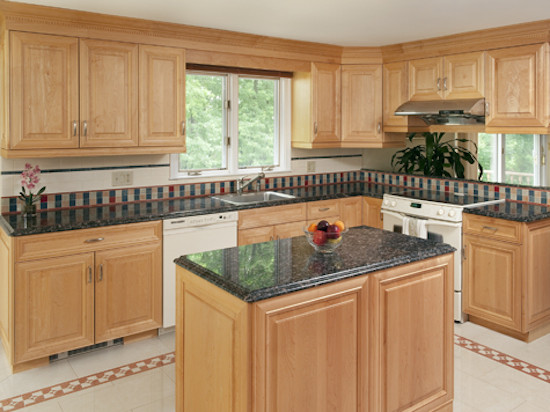 Kitchen photo in Boston with beaded inset cabinets, light wood cabinets, white backsplash and an island