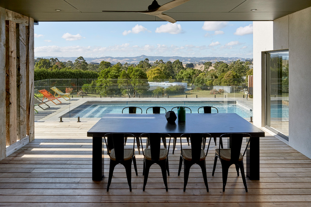 Photo of a contemporary backyard deck in Melbourne with a roof extension.