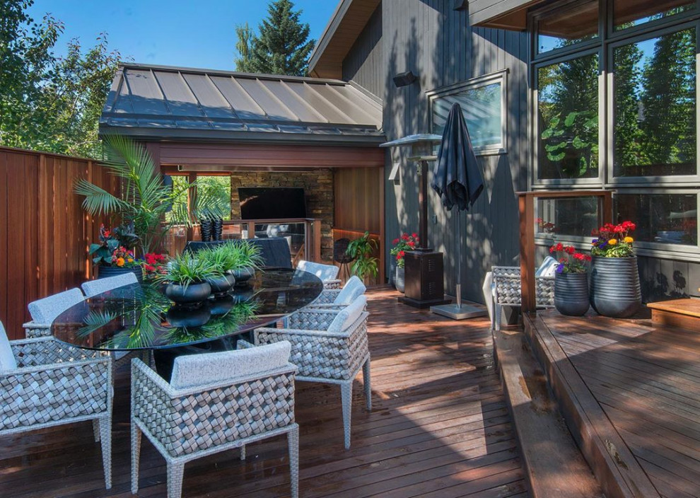 Inspiration for a large transitional backyard outdoor kitchen deck remodel in Calgary with no cover