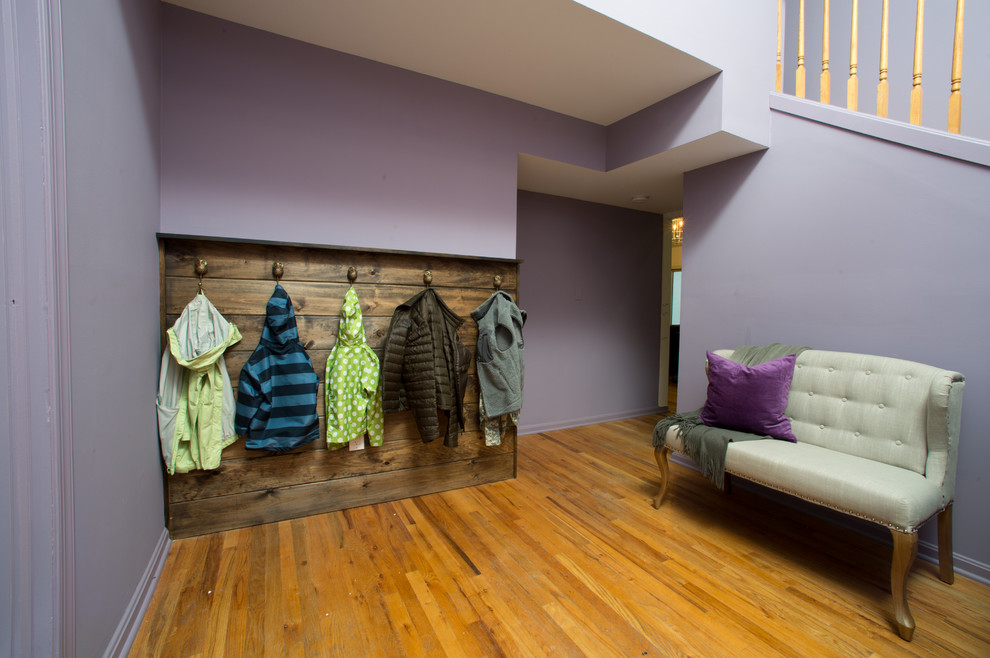 Design ideas for a contemporary entryway in DC Metro with purple walls and medium hardwood floors.