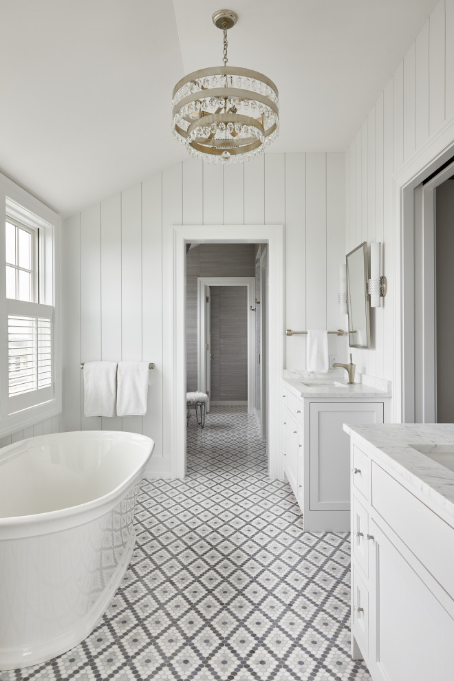 Design ideas for a beach style bathroom in Boston with recessed-panel cabinets, a freestanding tub, an alcove shower, mosaic tile, white walls, mosaic tile floors, an undermount sink, marble benchtops, grey floor, white benchtops, a built-in vanity, vaulted and planked wall panelling.