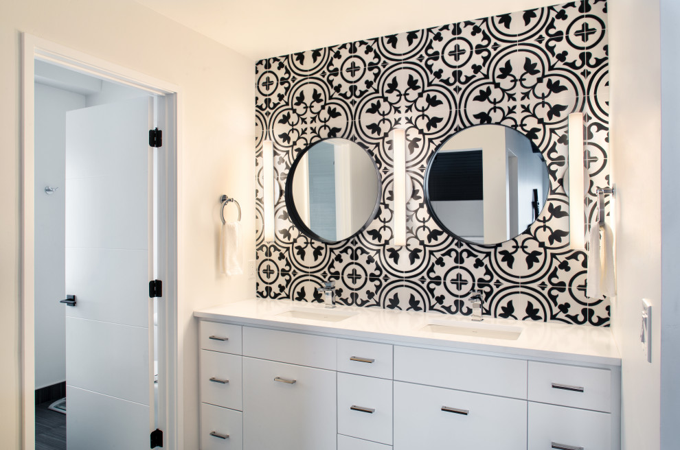 This is an example of a mid-sized contemporary master bathroom in Seattle with flat-panel cabinets, white cabinets, black and white tile, porcelain tile, an undermount sink, white benchtops, an enclosed toilet, a double vanity and a built-in vanity.