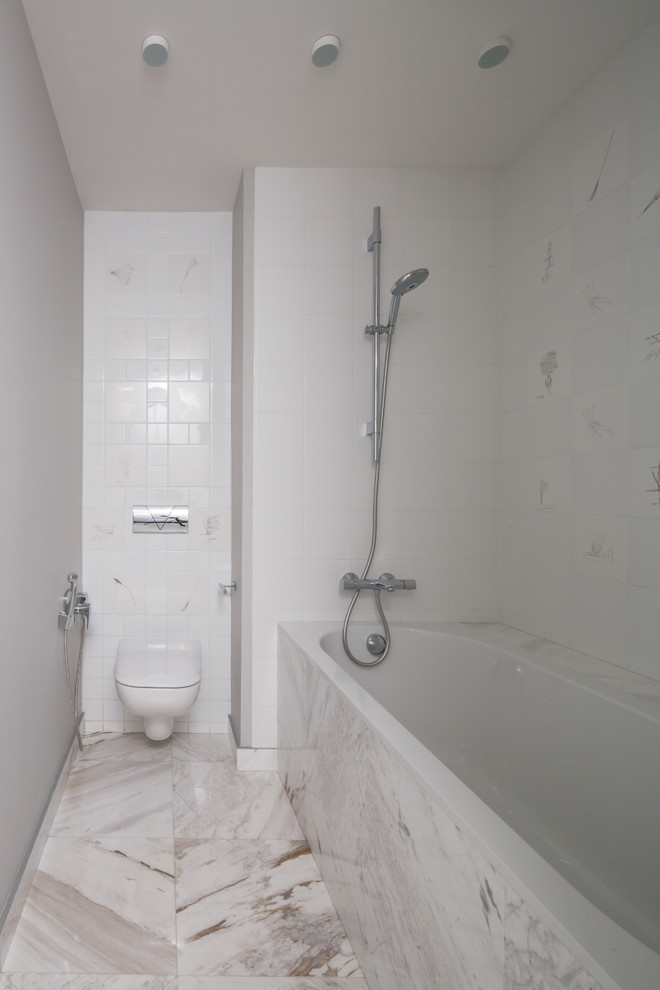 This is an example of a contemporary master bathroom in Moscow with a wall-mount toilet and white tile.