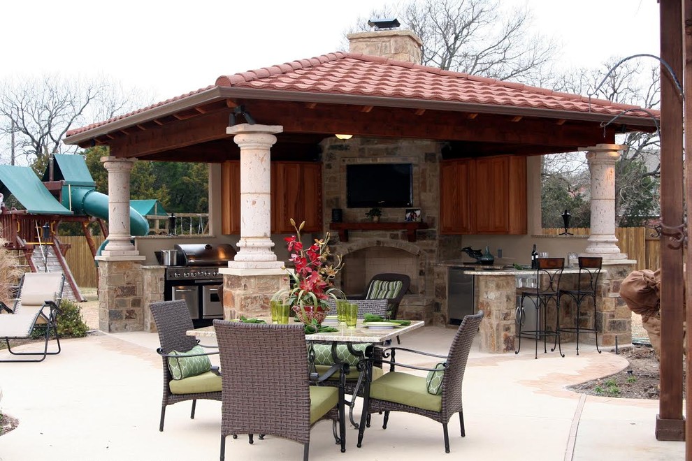 Large mediterranean backyard patio in Dallas with an outdoor kitchen, concrete slab and a gazebo/cabana.