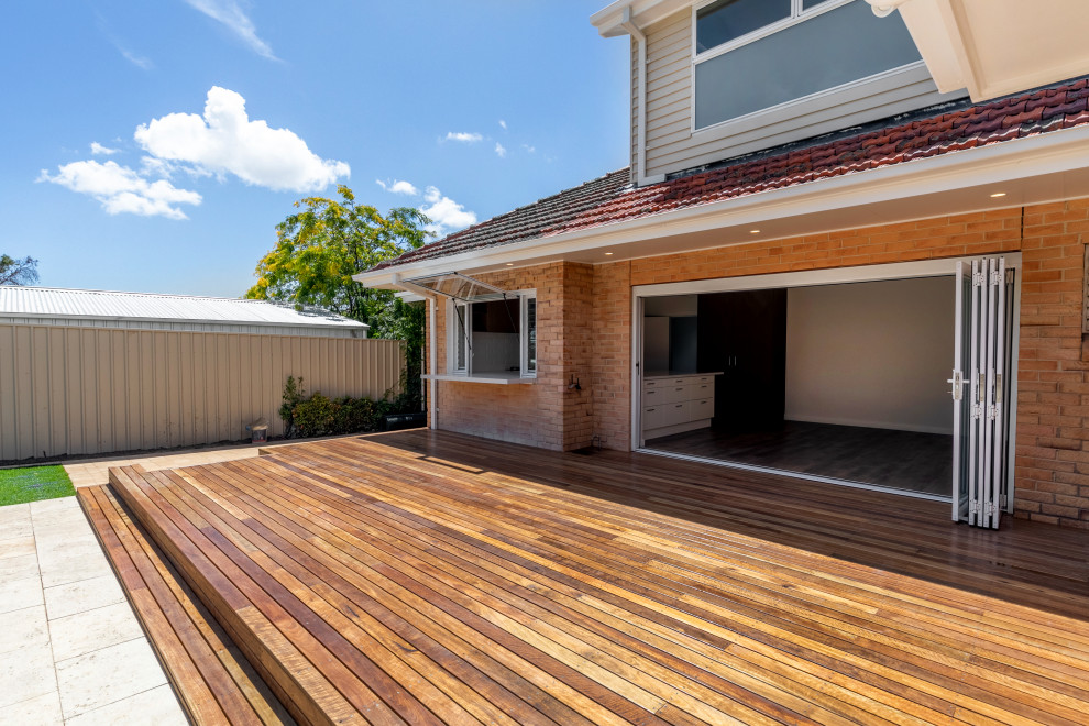 This is an example of a large midcentury back ground level terrace in Adelaide.