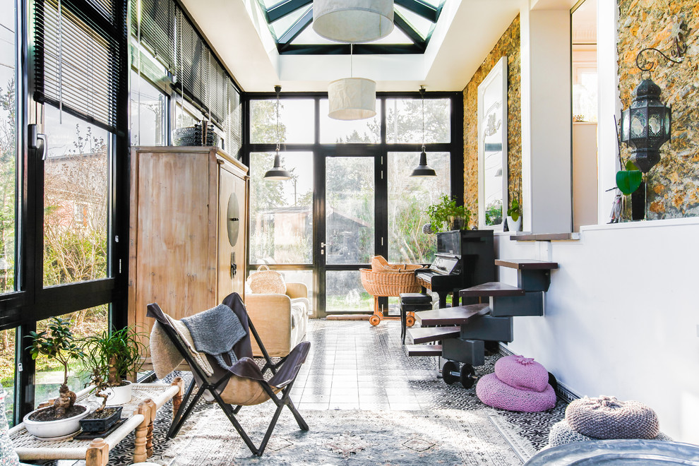 Inspiration for an eclectic sunroom in Paris with a skylight.