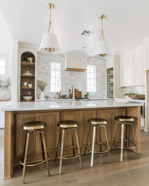 Light and airy kitchen with a wood island, brass stools and arched open kitchen cabinet shelves