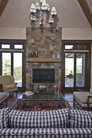 Photo of an expansive country formal open concept living room in Phoenix with beige walls, medium hardwood floors, a standard fireplace, a stone fireplace surround and no tv.