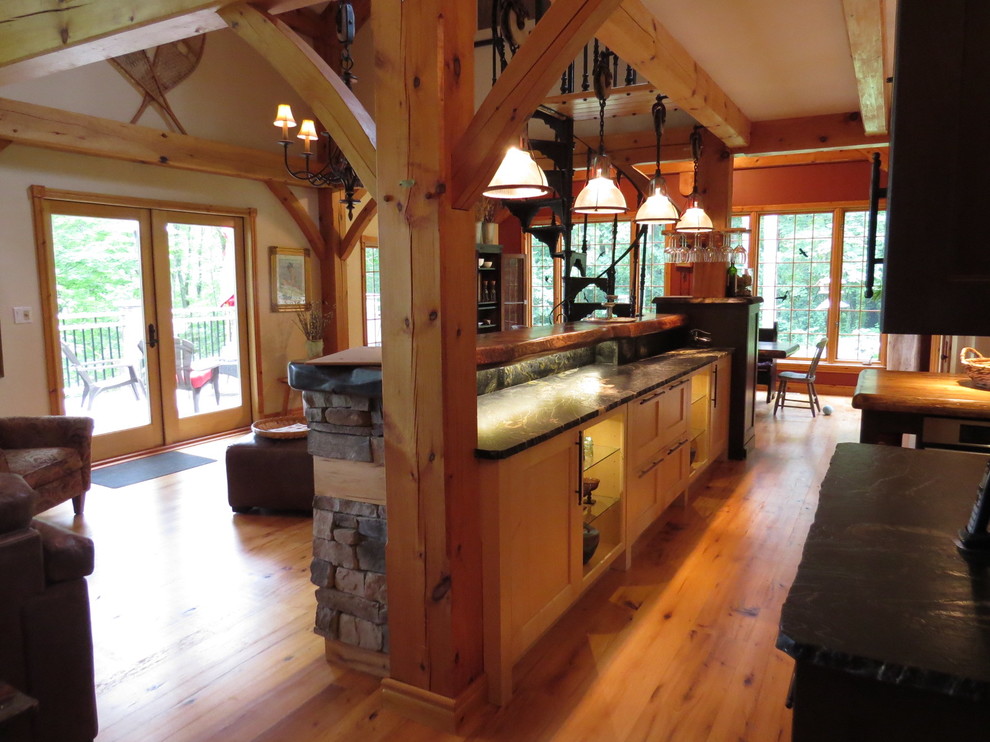 Example of a large mountain style u-shaped light wood floor eat-in kitchen design in Toronto with shaker cabinets, granite countertops, stone tile backsplash, an island, an undermount sink, light wood cabinets, gray backsplash and stainless steel appliances