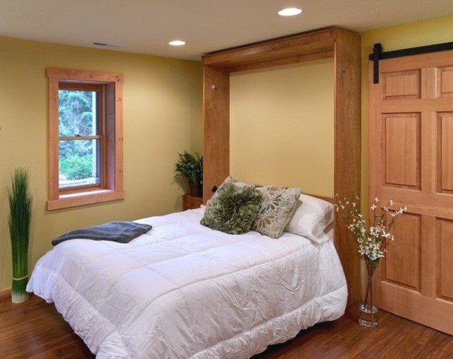 Bedroom - large rustic dark wood floor bedroom idea with yellow walls