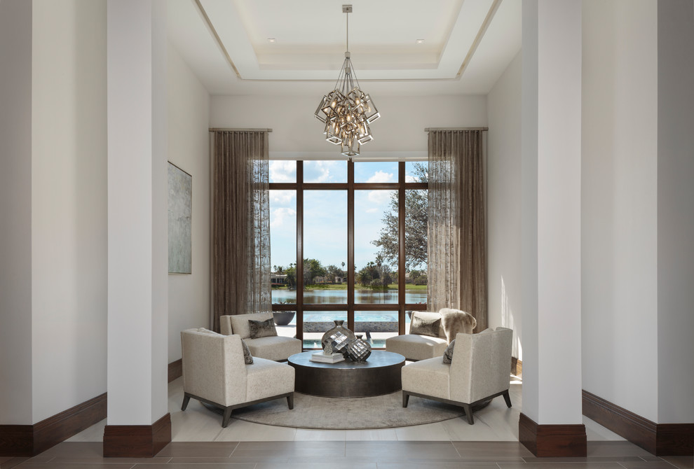 This is an example of a mid-sized modern formal living room in Miami with white walls, porcelain floors, no fireplace, no tv and beige floor.