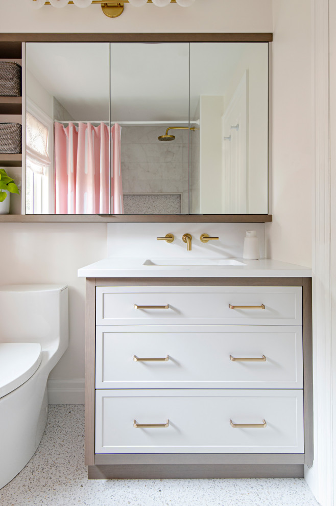 Example of a small trendy ceramic tile, multicolored floor and single-sink bathroom design in Toronto with shaker cabinets, white cabinets, a one-piece toilet, white walls, an undermount sink, quartz countertops and white countertops