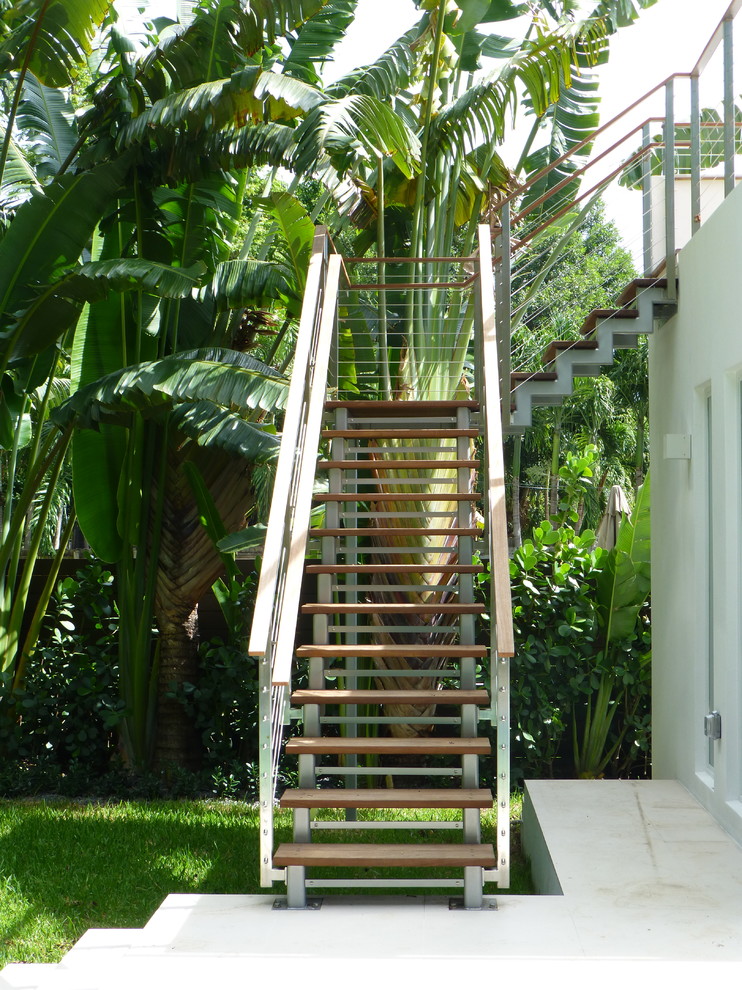 Design ideas for a tropical wood staircase in Miami with open risers.