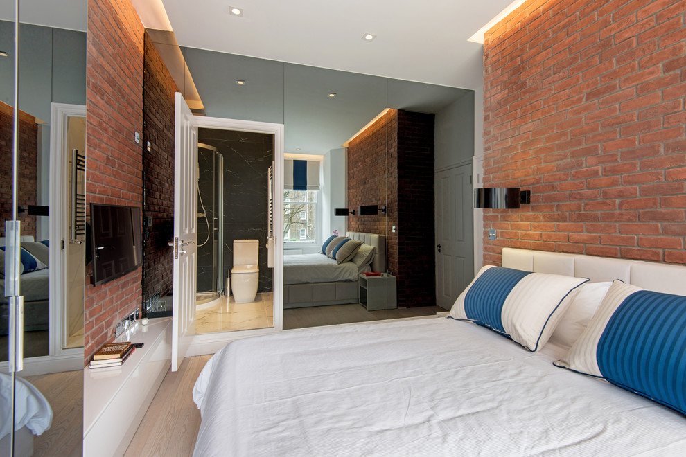 This is an example of a large contemporary master bedroom in London with multi-coloured walls and dark hardwood floors.