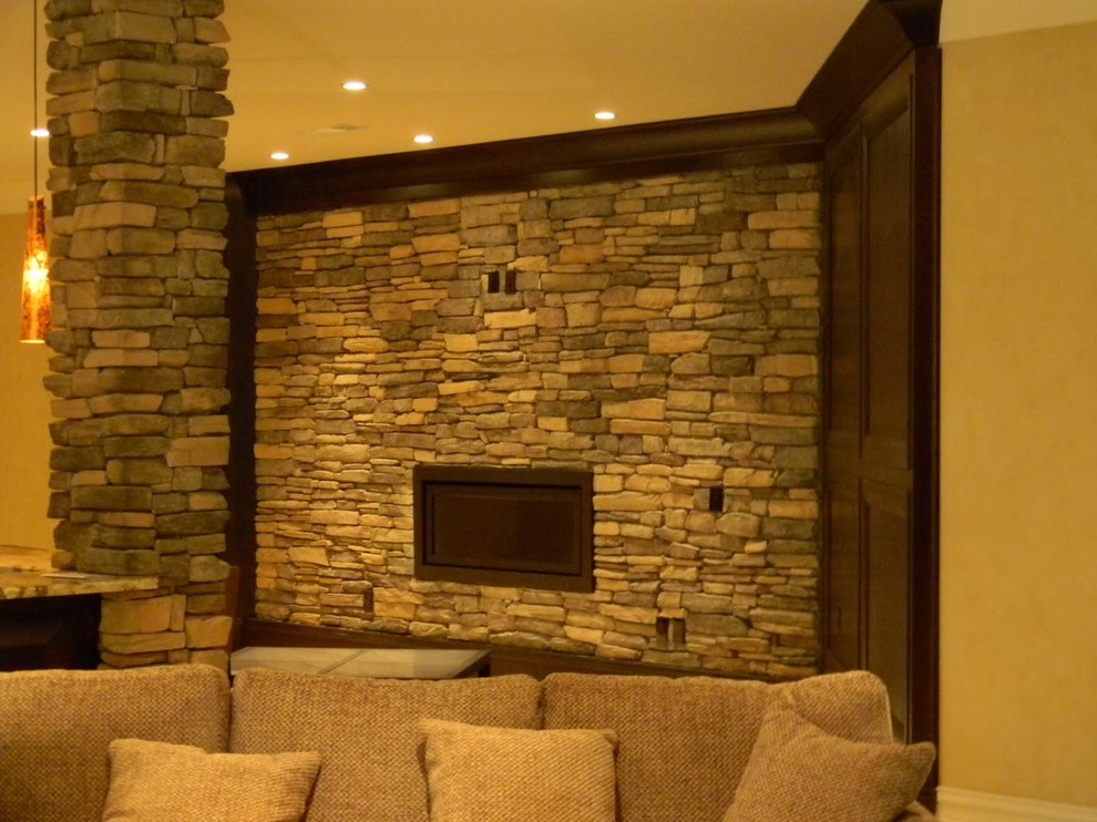 Inspiration for a large contemporary fully buried basement in Atlanta with beige walls, ceramic floors, a standard fireplace, a stone fireplace surround and beige floor.