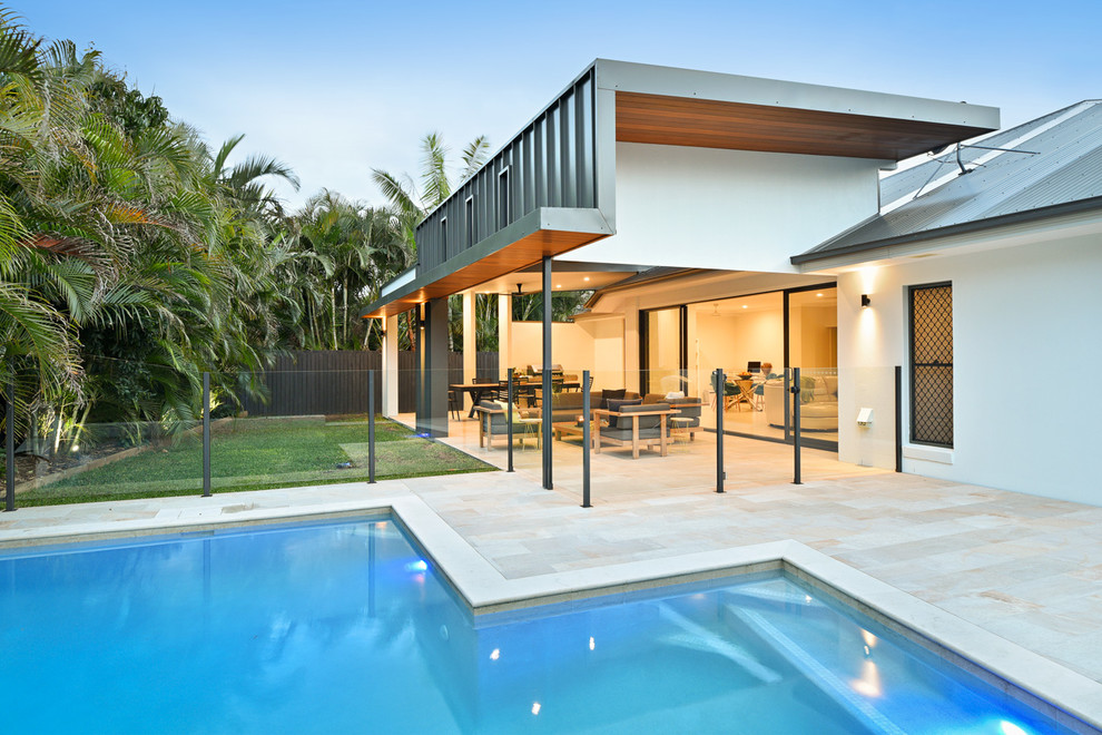 Design ideas for a mid-sized contemporary backyard patio in Brisbane with tile and a roof extension.