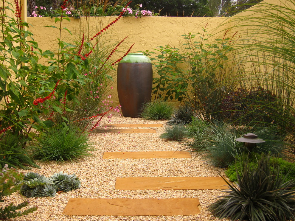 This is an example of a large mediterranean courtyard partial sun xeriscape in San Francisco with gravel.