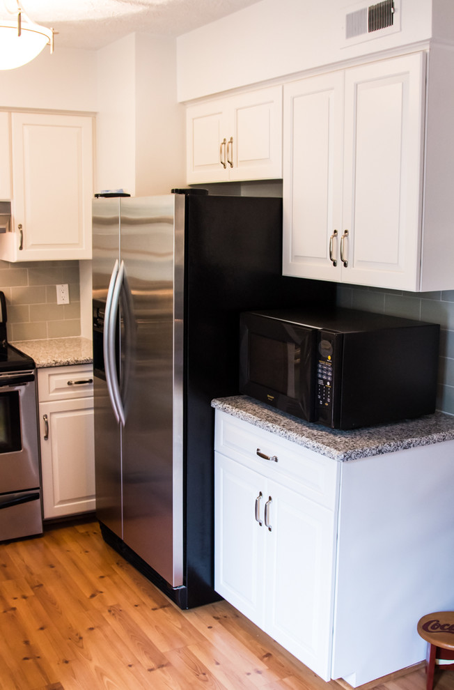 Inspiration for a small transitional u-shaped light wood floor kitchen remodel in Baltimore with an undermount sink, raised-panel cabinets, white cabinets and no island