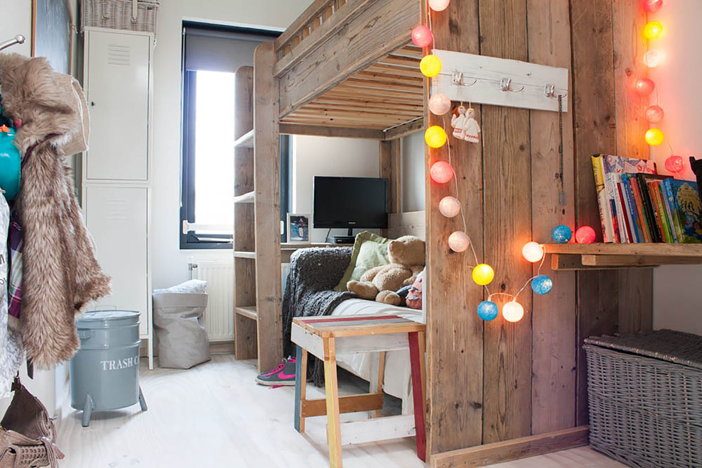 Photo of an eclectic kids' bedroom for kids 4-10 years old and boys in Amsterdam with white walls.