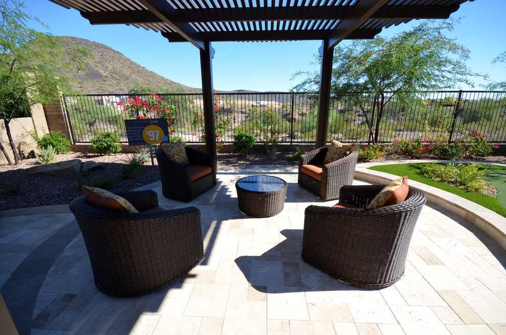 Photo of a mid-sized contemporary backyard patio in Phoenix with concrete pavers and a roof extension.