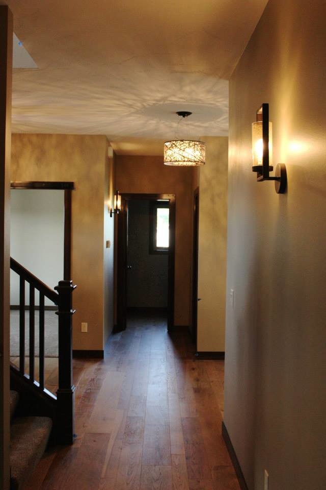 Mid-sized transitional medium tone wood floor entry hall photo with beige walls and a dark wood front door