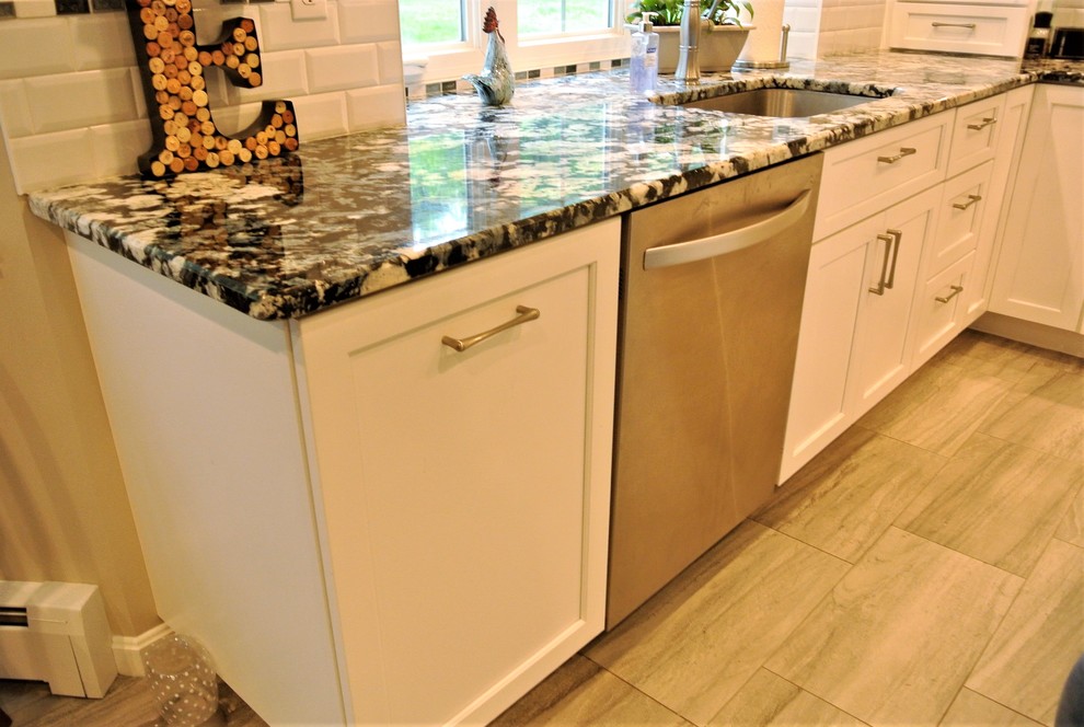 Inspiration for a transitional kitchen remodel in Boston with an undermount sink, shaker cabinets, granite countertops, subway tile backsplash, stainless steel appliances and an island