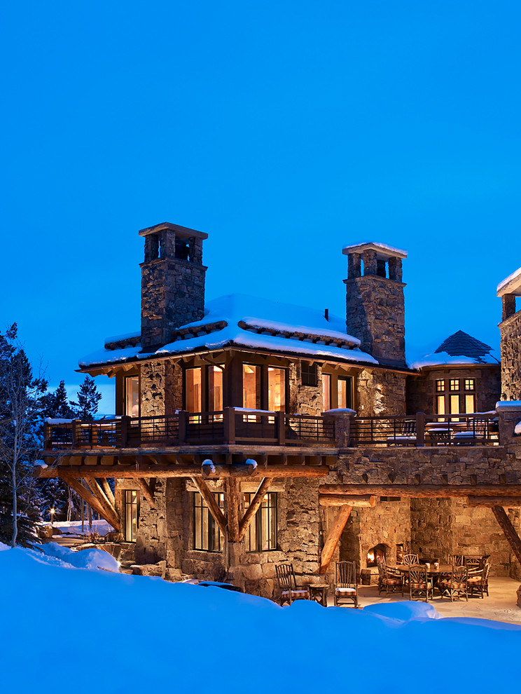 Inspiration for an expansive country two-storey exterior in Denver with stone veneer and a hip roof.
