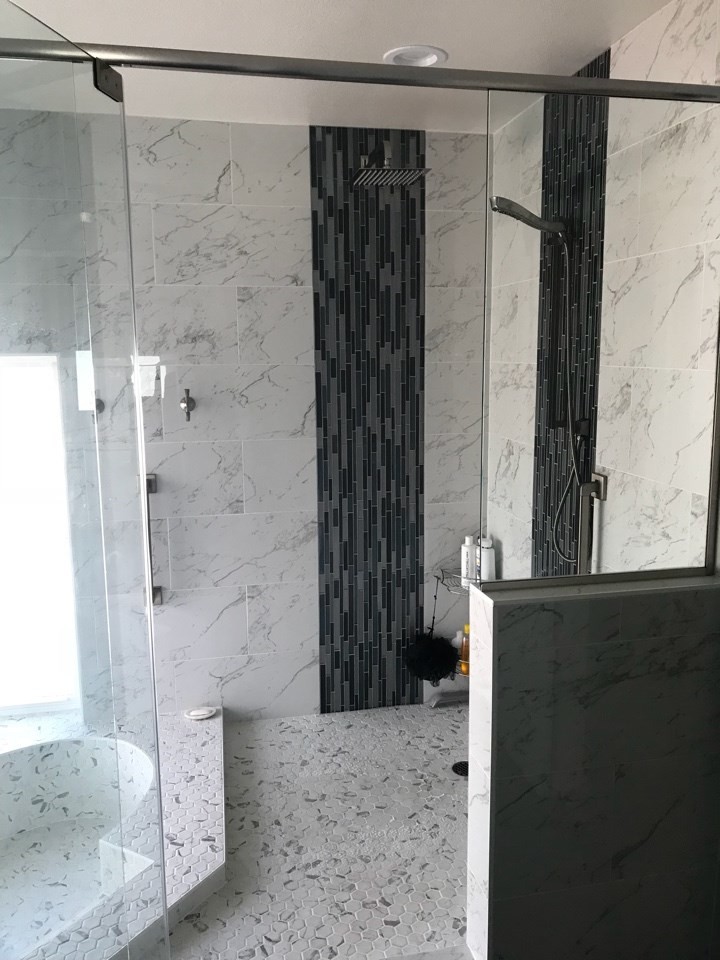 Photo of a large modern master wet room bathroom in Phoenix with a corner tub, black and white tile and a hinged shower door.