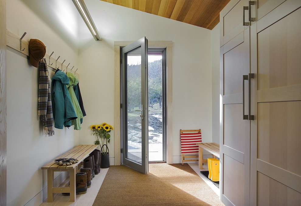 Country mudroom in Boston with white walls, light hardwood floors, a single front door and a glass front door.