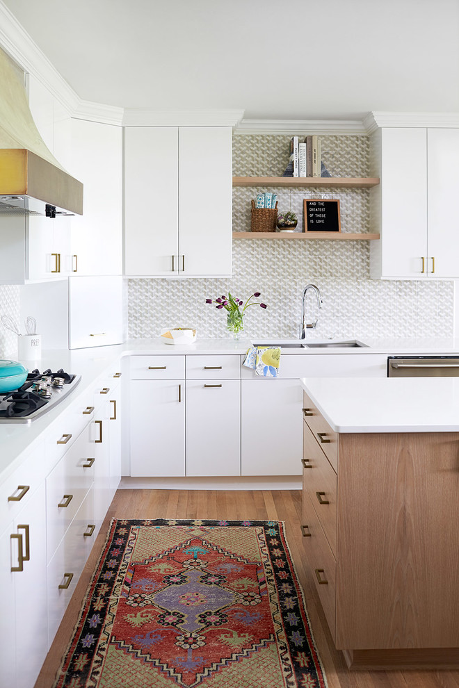 Inspiration for a contemporary l-shaped kitchen in Raleigh with a double-bowl sink, flat-panel cabinets, white cabinets, grey splashback, stainless steel appliances, medium hardwood floors and with island.