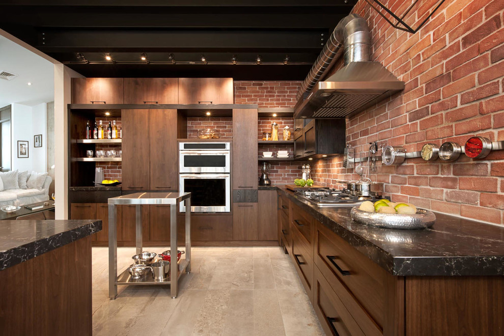 Large industrial l-shaped kitchen in Montreal with a double-bowl sink, quartzite benchtops, stainless steel appliances, with island and matchstick tile splashback.