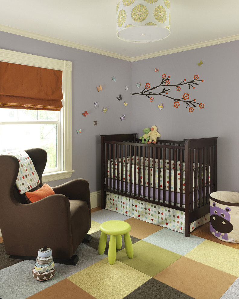Photo of a transitional gender-neutral nursery in Boston with grey walls and carpet.