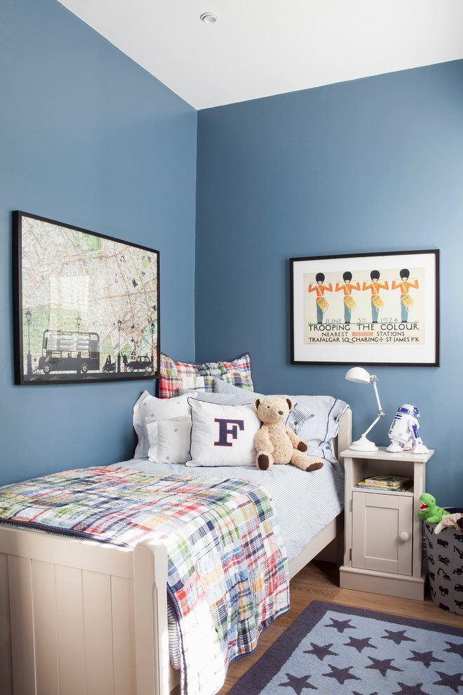 Inspiration for a small transitional kids' bedroom for kids 4-10 years old and boys in Other with blue walls and medium hardwood floors.