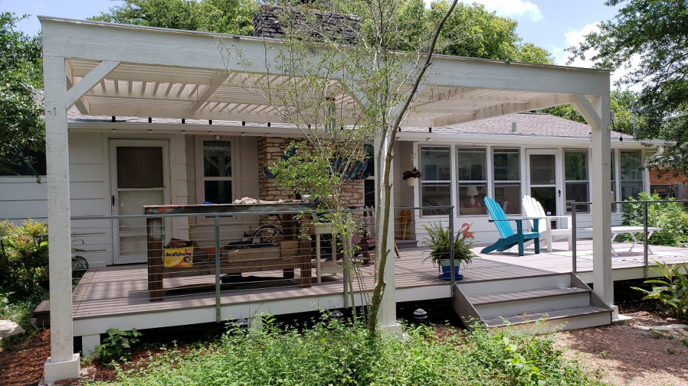 Example of a large cottage chic backyard deck design in Austin with a pergola