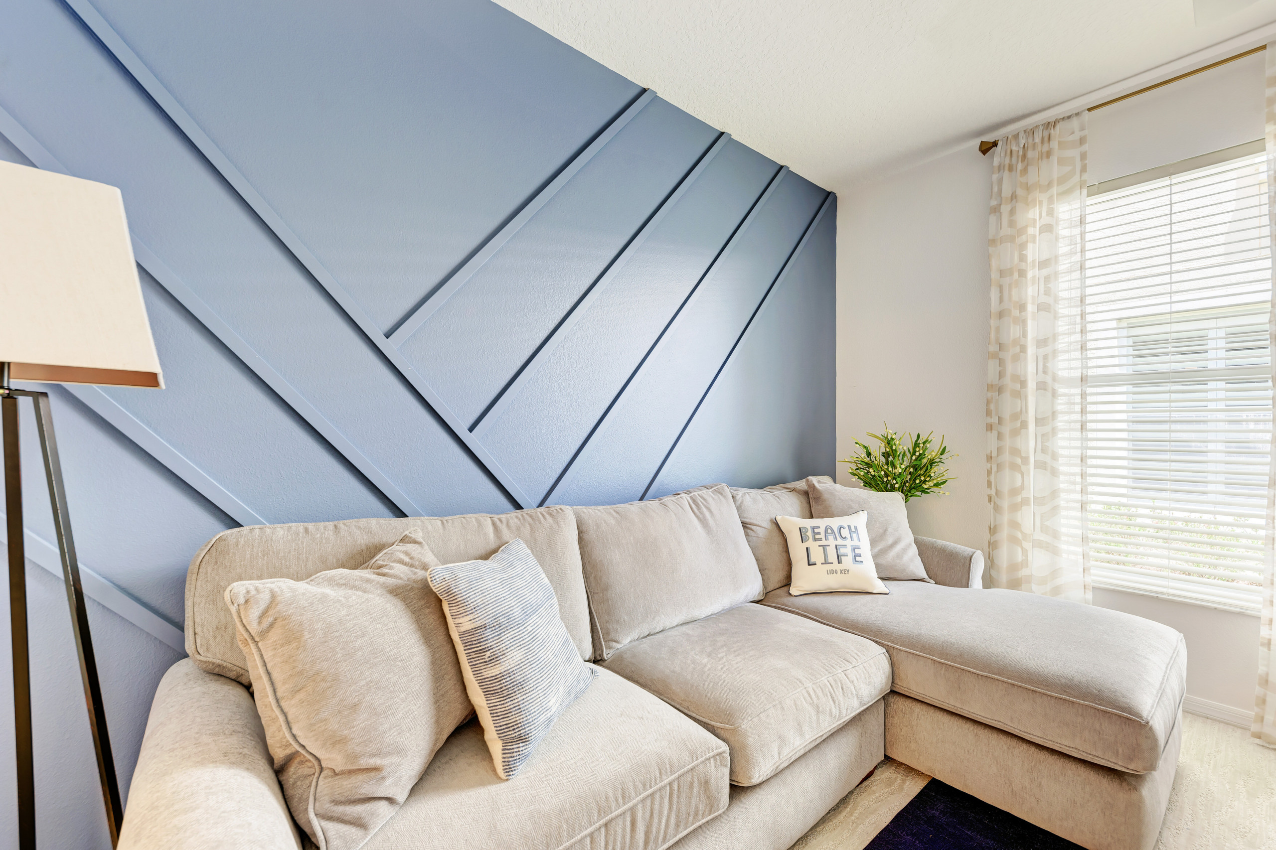 Shiplap wall family room photo in Tampa with blue walls and no tv