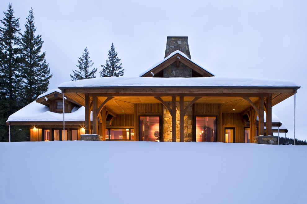 This is an example of a mid-sized country one-storey brown house exterior in Boise with wood siding and a hip roof.
