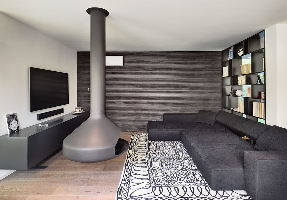 Inspiration for a contemporary family room in Bologna with a hanging fireplace.