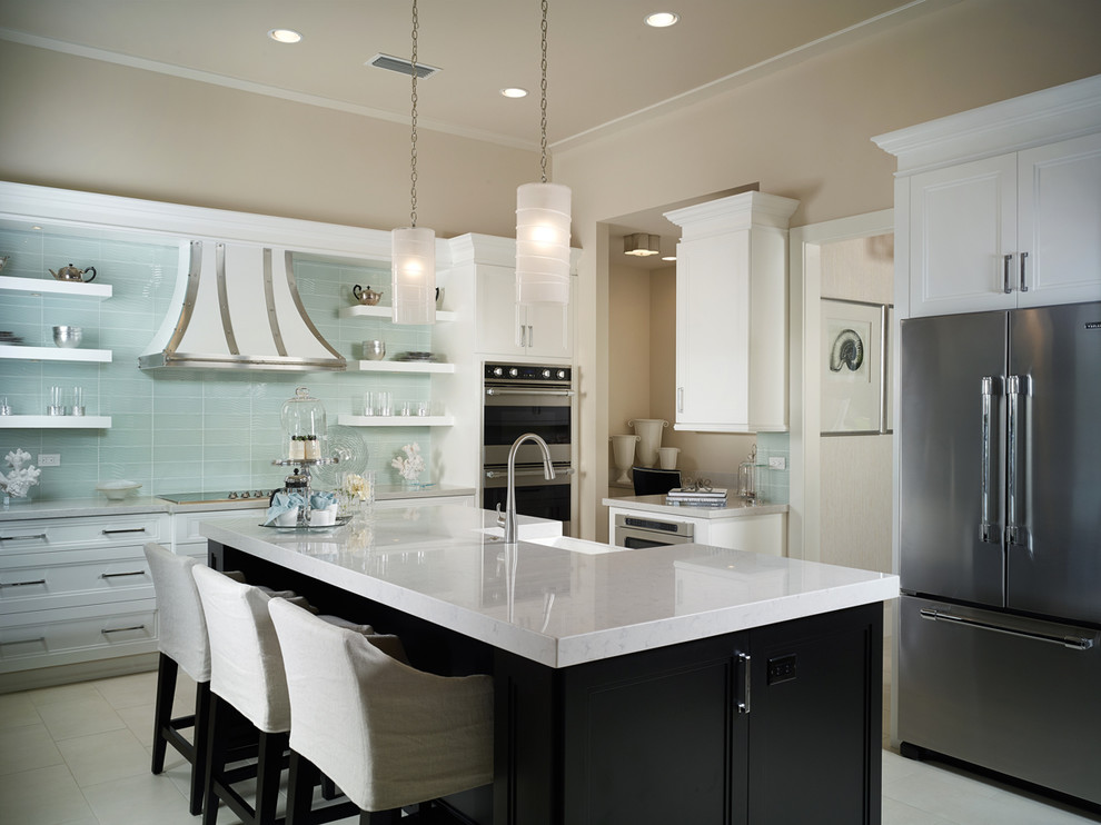 Inspiration for a mid-sized contemporary separate kitchen in Miami with stainless steel appliances, a farmhouse sink, recessed-panel cabinets, white cabinets, marble benchtops, glass tile splashback, limestone floors and with island.