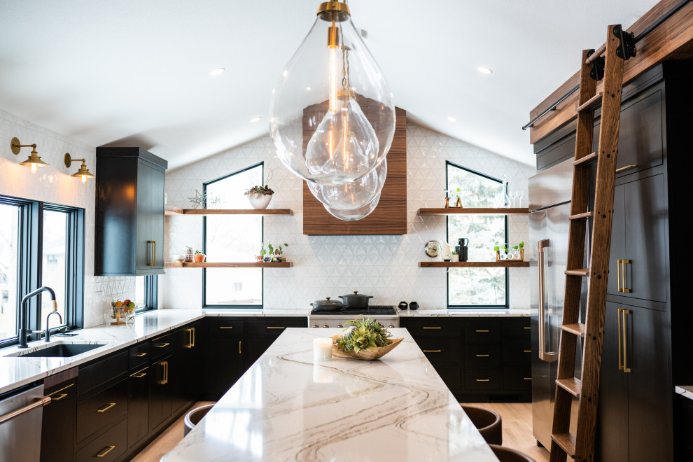 Inspiration for a midcentury kitchen in Other with an undermount sink, flat-panel cabinets, black cabinets, quartz benchtops, white splashback, ceramic splashback, stainless steel appliances, light hardwood floors, with island, multi-coloured benchtop and vaulted.