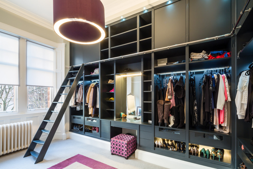 Photo of a contemporary women's dressing room in Glasgow with open cabinets, black cabinets, carpet and beige floor.