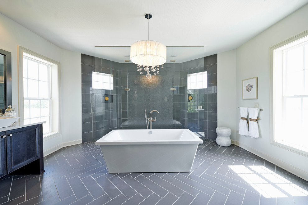 Photo of an expansive transitional master bathroom in Columbus with a freestanding tub, a curbless shower and gray tile.