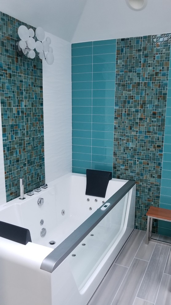 Mid-sized beach style master bathroom in Seattle with flat-panel cabinets, blue cabinets, a hot tub, a double shower, multi-coloured tile, glass tile, grey walls, ceramic floors, an undermount sink, engineered quartz benchtops, grey floor, a hinged shower door and multi-coloured benchtops.